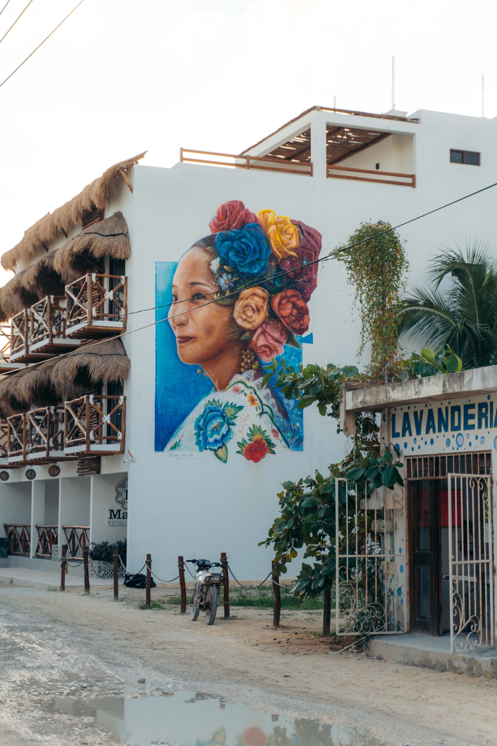 Colorful street art of a woman painted on the wall of Hotel Mayari in Holbox.