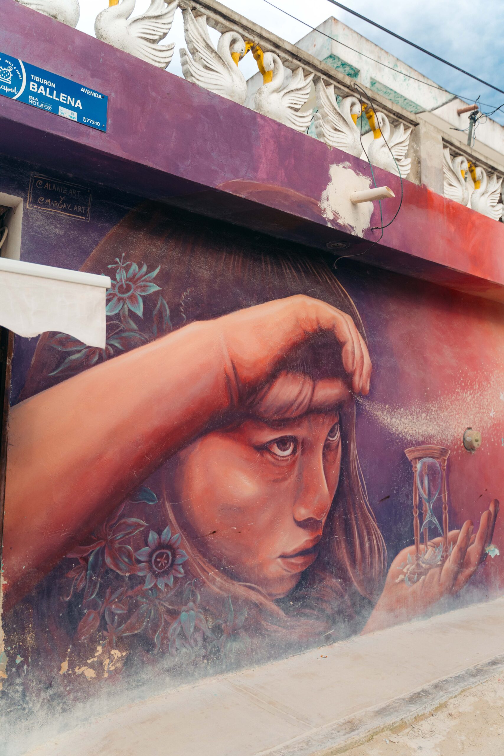 Street art titled 'Time Flies' on Calle Tiburon Ballena in Holbox.