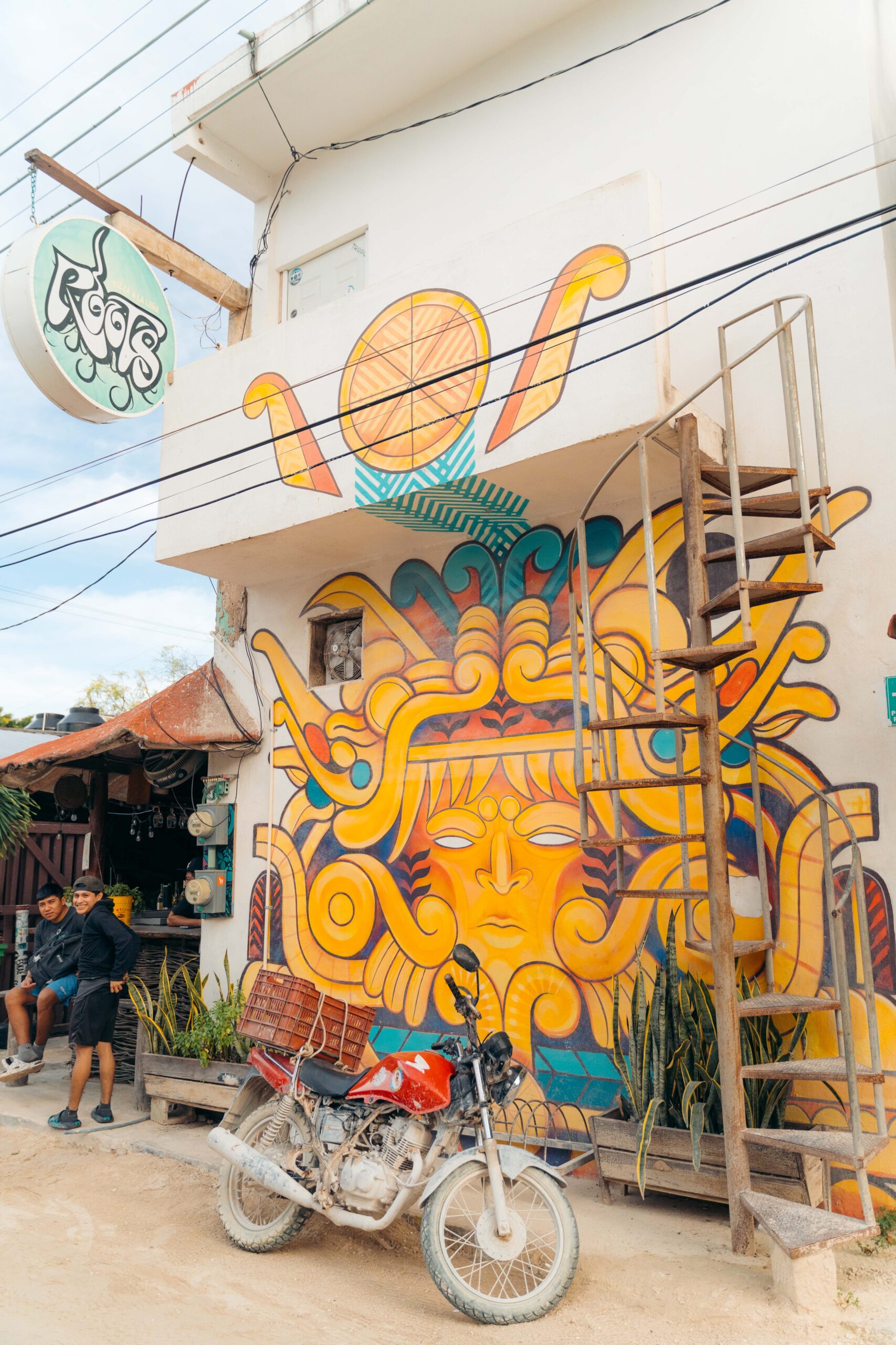 Exterior and interior murals at Roots Pizza a la Leña in Holbox.
