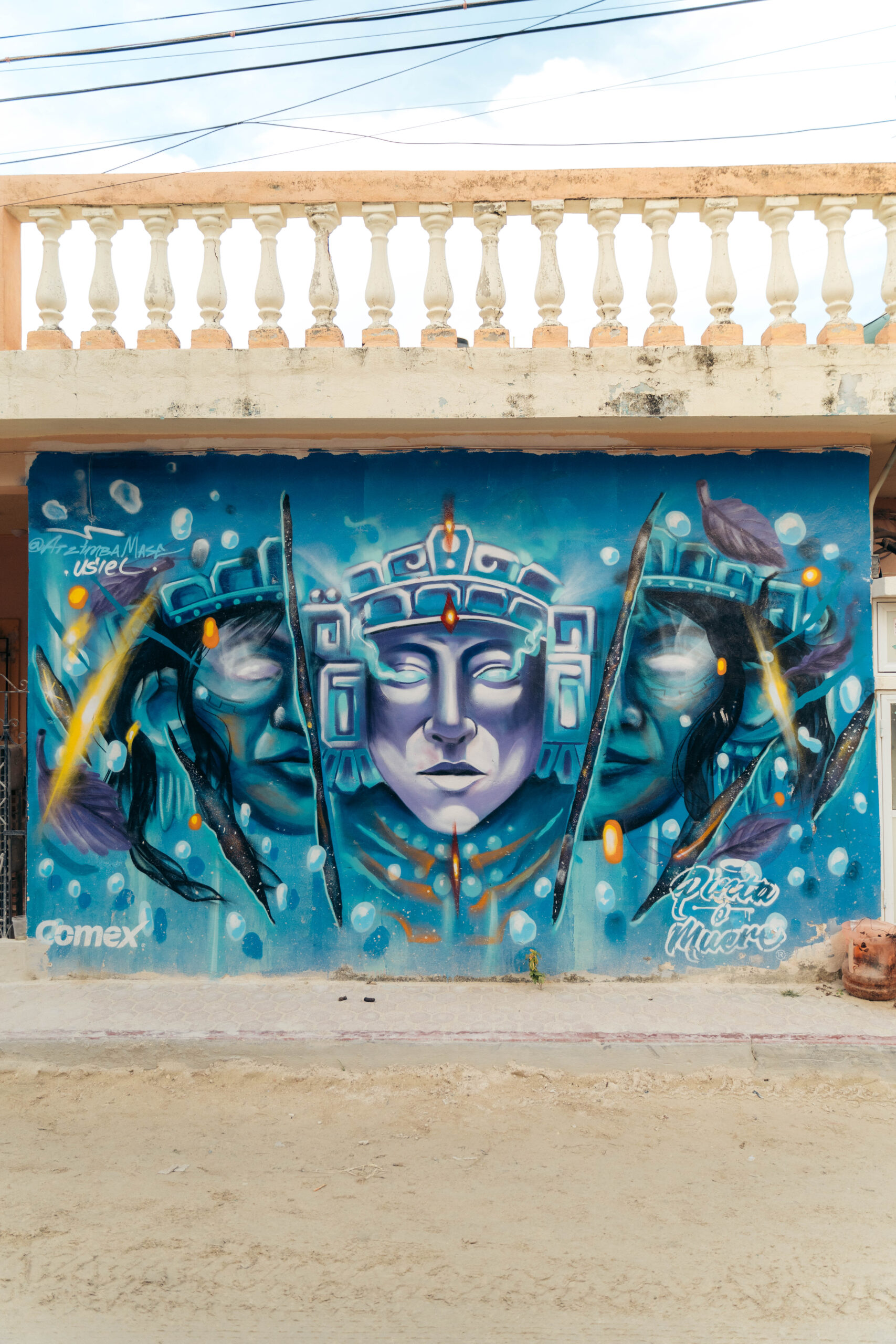 Colorful mural of a futuristic scene featuring vibrant and surreal elements on Calle Carito in Holbox Island.