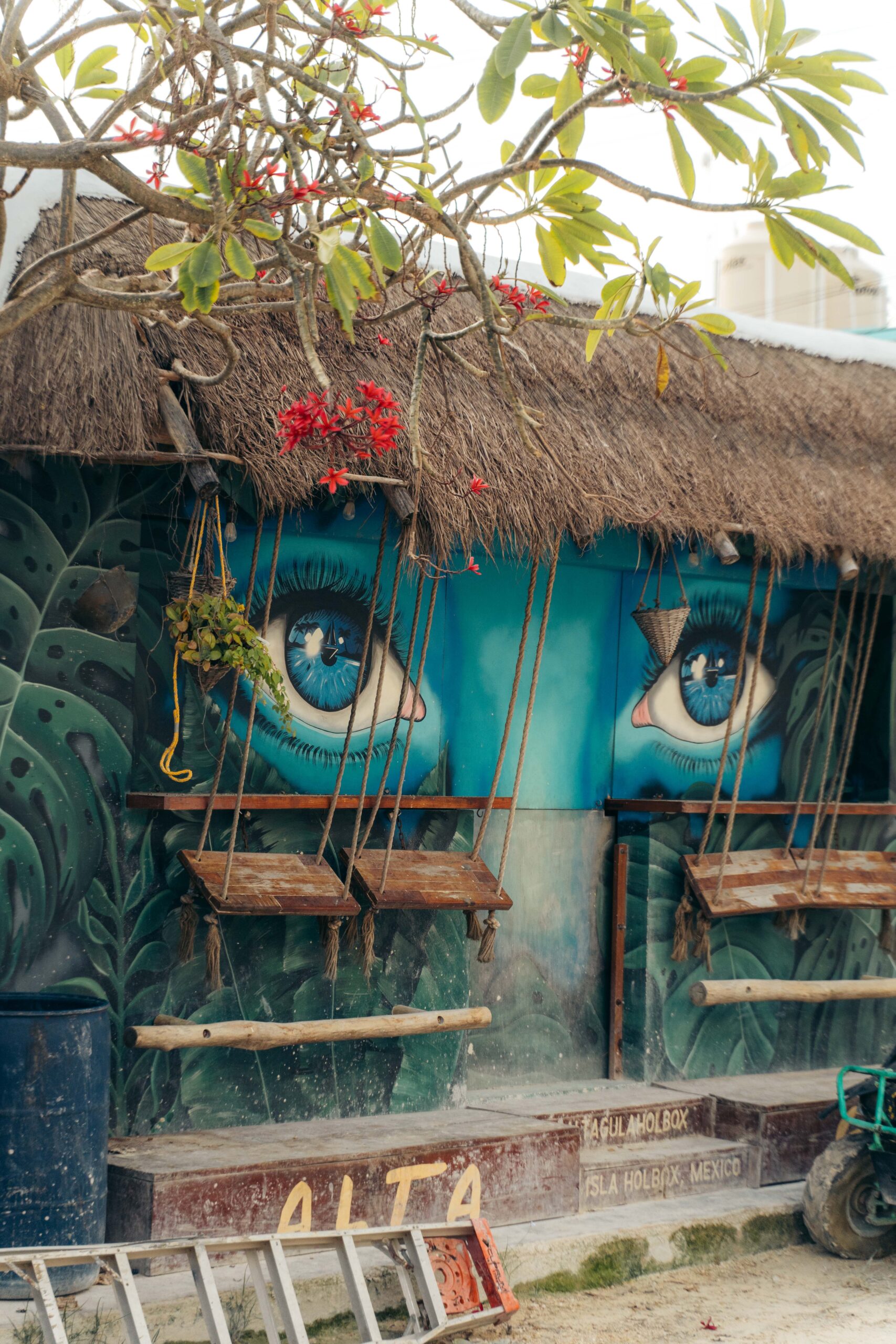 Mural of expressive eyes on Calle Carito in Holbox Island, creating an introspective atmosphere.